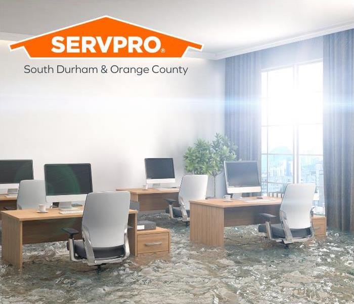 Office with desks, computers, and chairs flooded
